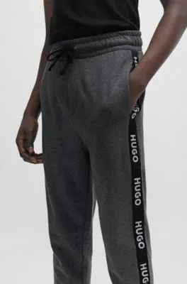 Cuffed tracksuit bottoms in with logo tape