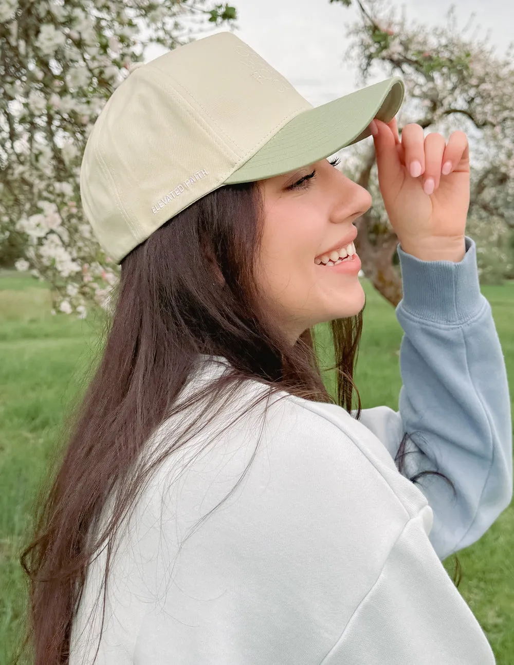 God Works for the Good Trucker Hat