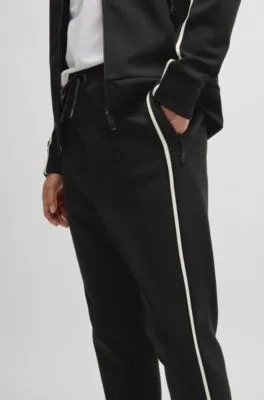 Tracksuit bottoms with tape inserts