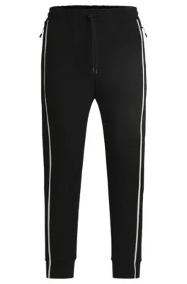 Tracksuit bottoms with tape inserts